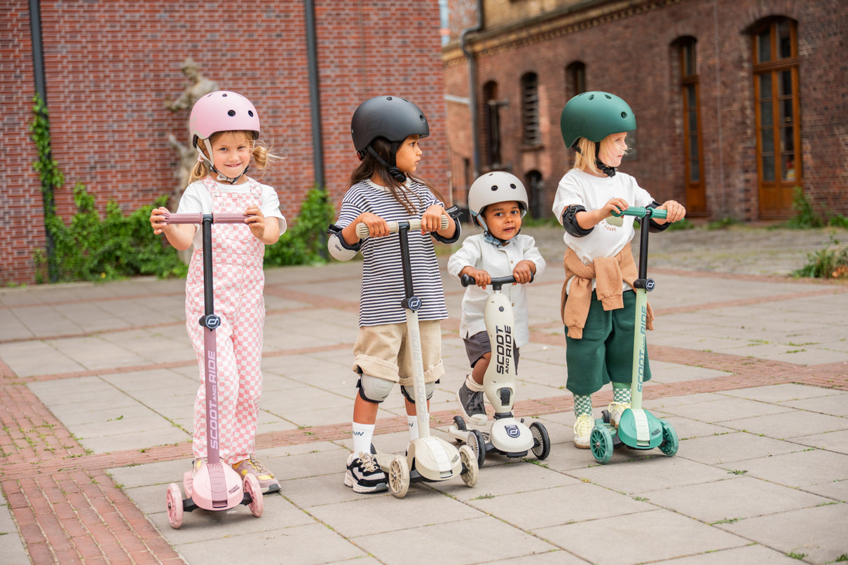 Group lifestyle shot of Scoot and Ride scooters, showing children at different stages of the 5-year-old transition journey.