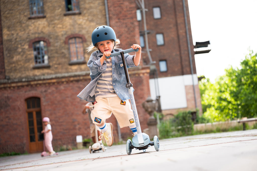 A young rider testing out the Scoot and Ride Highway Kick 3S LED scooter