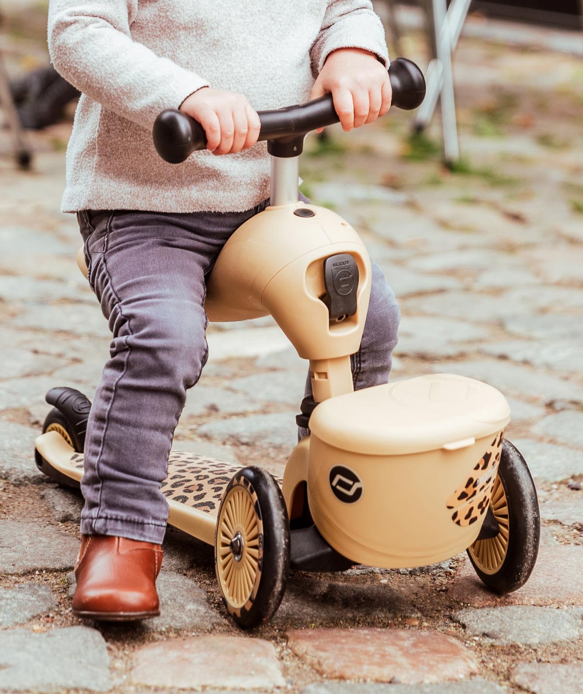 Toddler exploring outdoors with a stylish Scoot and Ride Highwaykick 1 Leopard