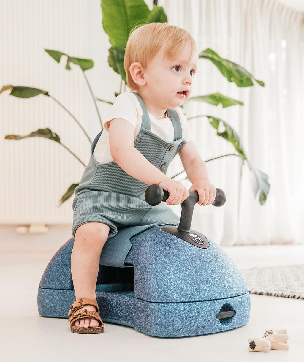 A toddler playing safely with the My First Ride On Walker