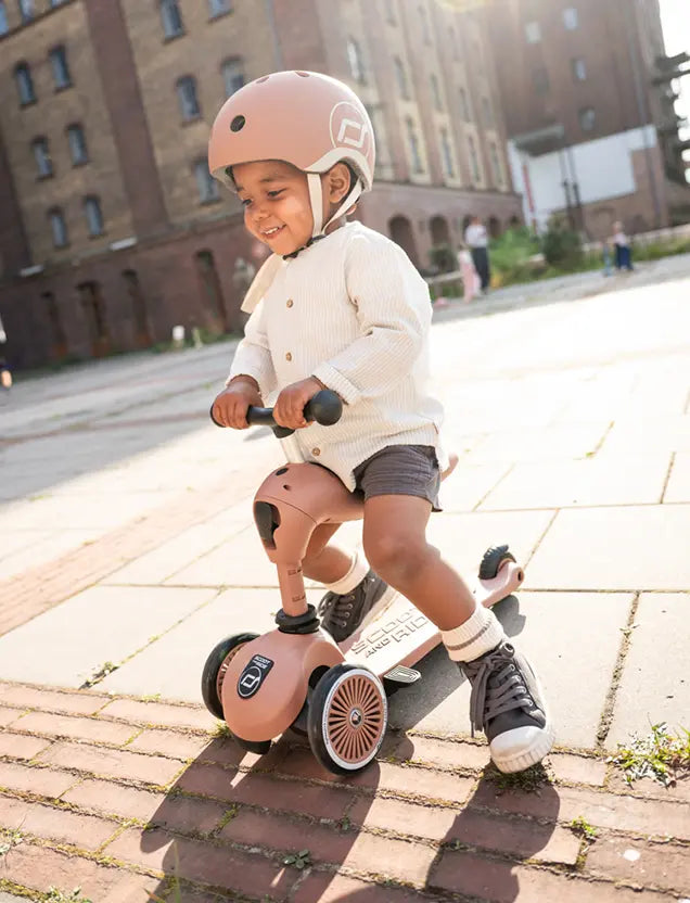 Young boy enjoying outdoor ride on the Scoot and Ride Highwaykick 1 Push and Go Mocha