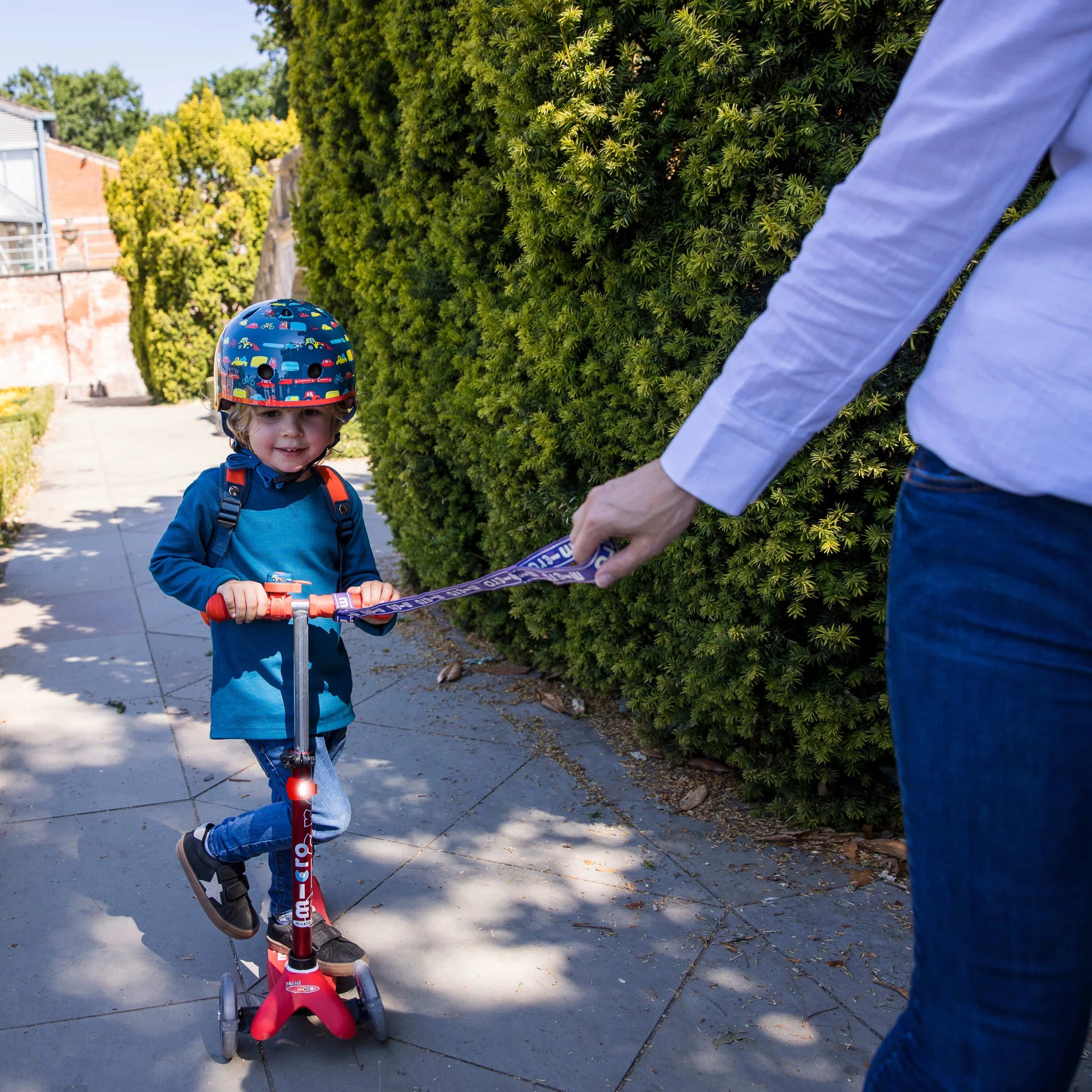 Parent using the Micro Scooter Eco Pull and Carry Strap in Blue